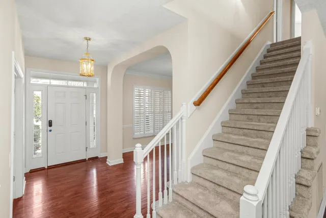 a view of entryway and hall with wooden floor