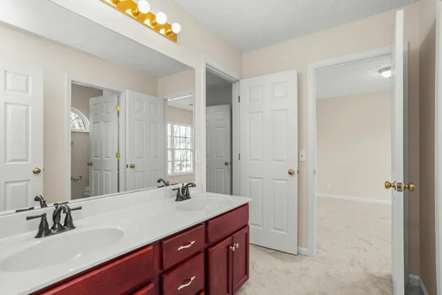 a bathroom with a double vanity sink and mirror