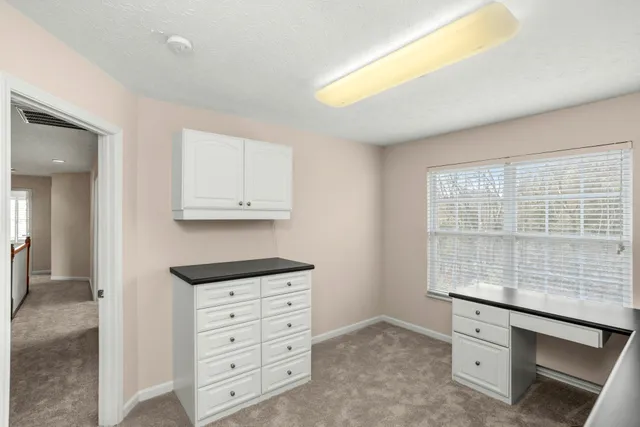 a view of a hallway with wooden floor and entryway