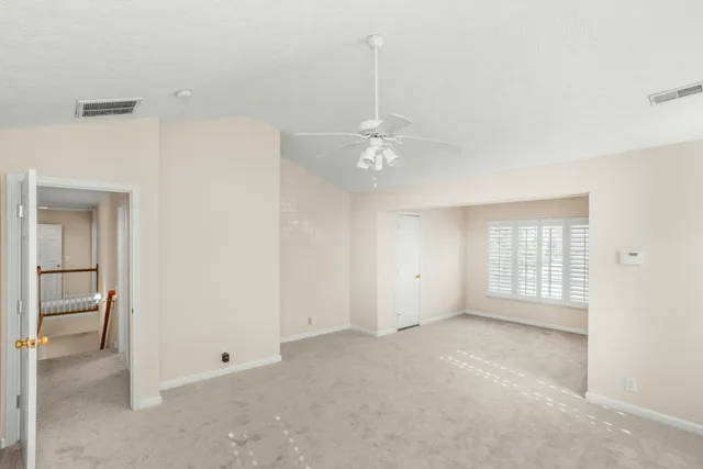a bathroom with a tub a sink double vanity and a mirror