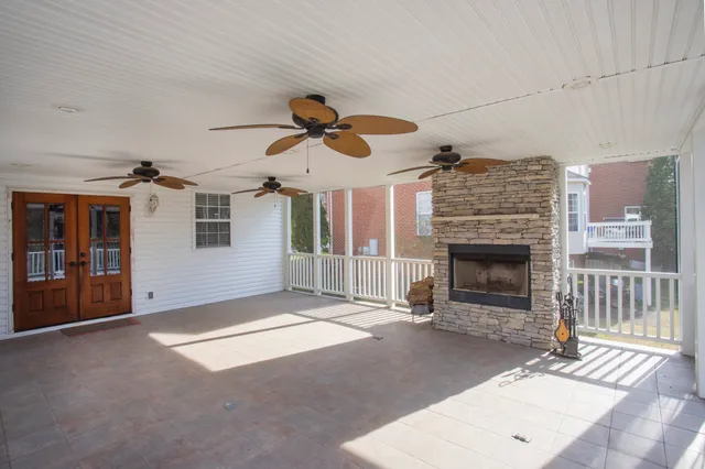 a view of a livingroom with a ceiling fan and window