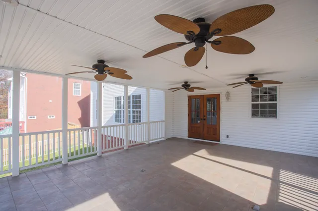 a view of a livingroom with wooden floor and a ceiling fan