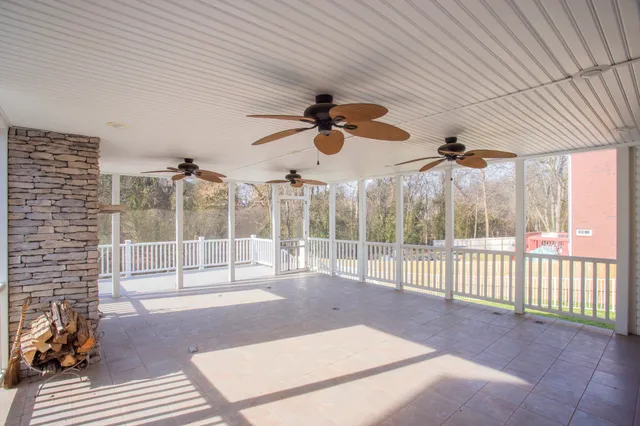 a view of a balcony with wooden floor and fence