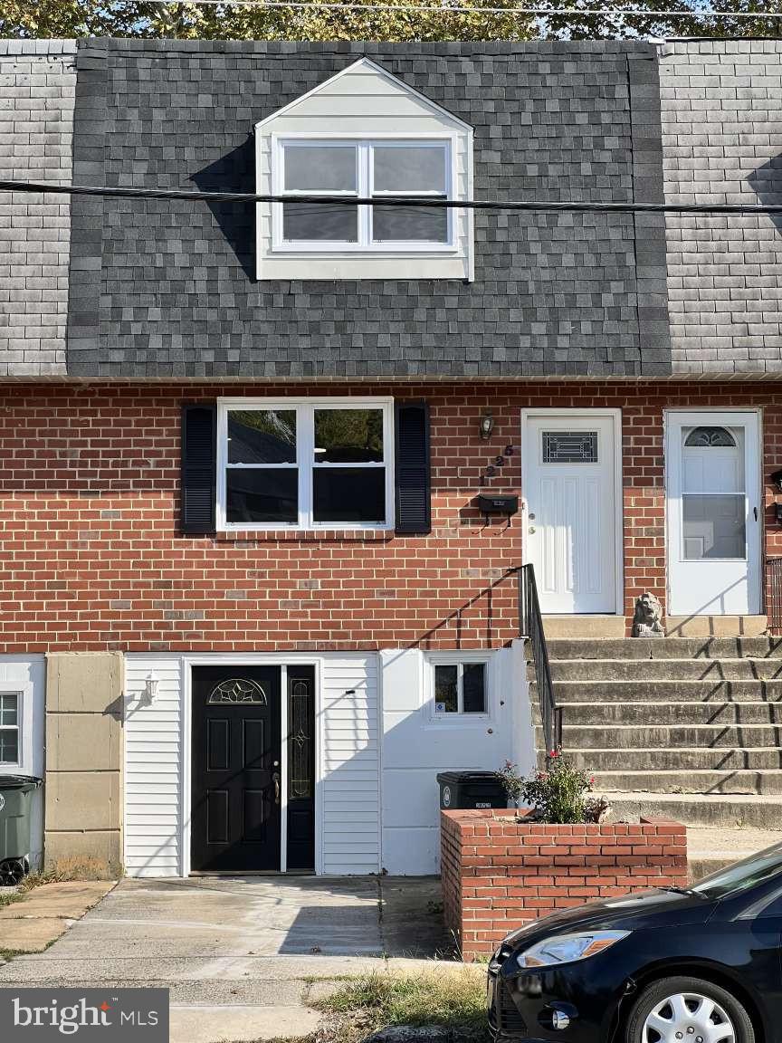 1225 Rainer Road Brookhaven, PA 19015 - Photo 12 of 15 a front view of a house with parking