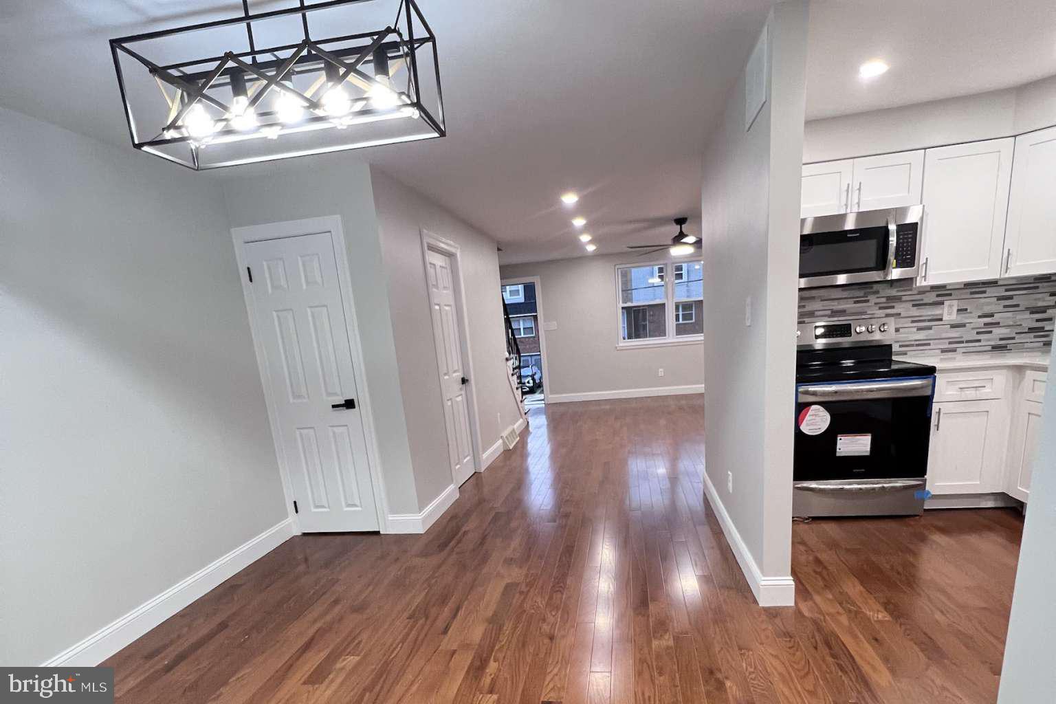 1225 Rainer Road Brookhaven, PA 19015 - Photo 4 of 15 a view of a kitchen with wooden floor and a refrigerator