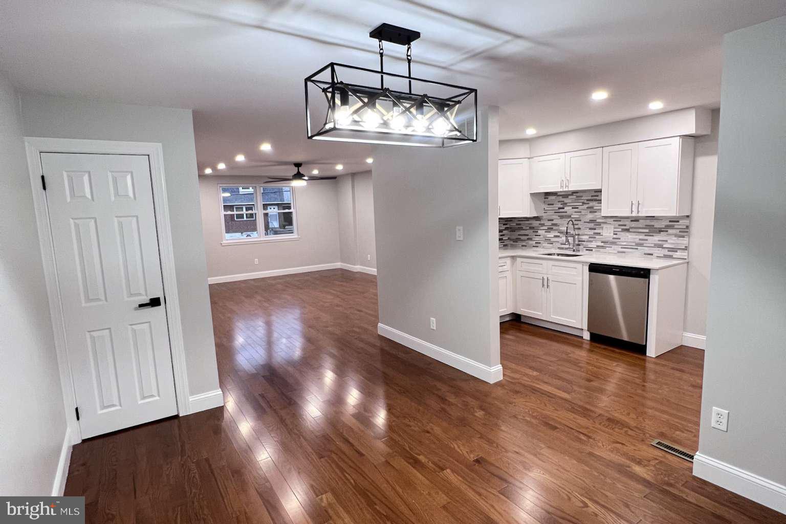 1225 Rainer Road Brookhaven, PA 19015 - Photo 6 of 15 a view of a kitchen with wooden floor and a refrigerator
