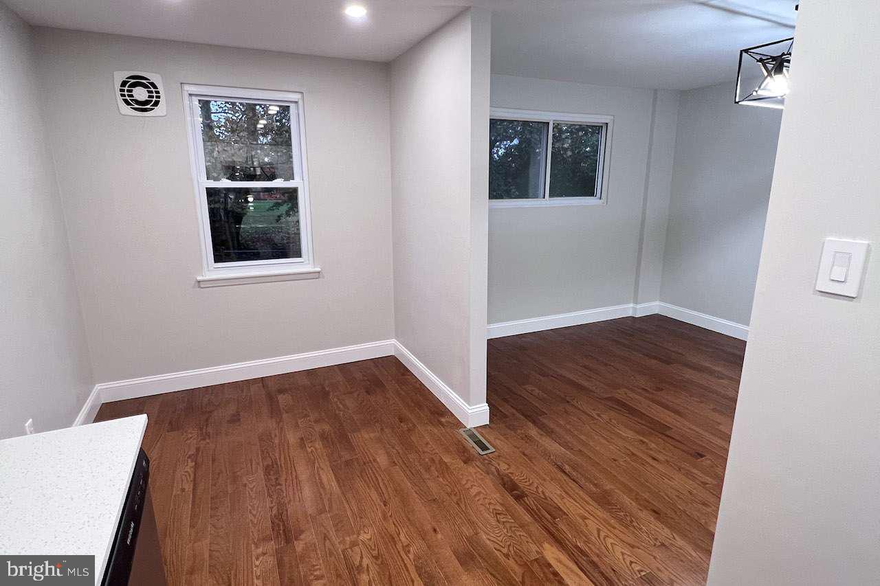 1225 Rainer Road Brookhaven, PA 19015 - Photo 7 of 15 an empty room with wooden floor and windows