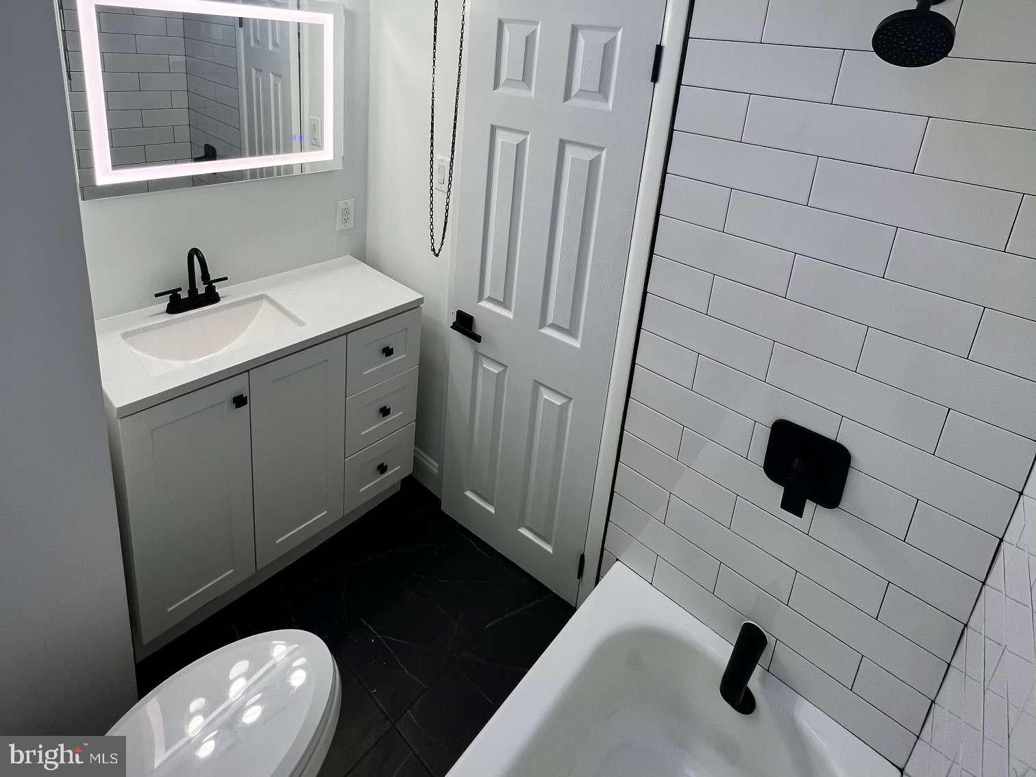 1225 Rainer Road Brookhaven, PA 19015 - Photo 8 of 15 a bathroom with a toilet a sink and a mirror