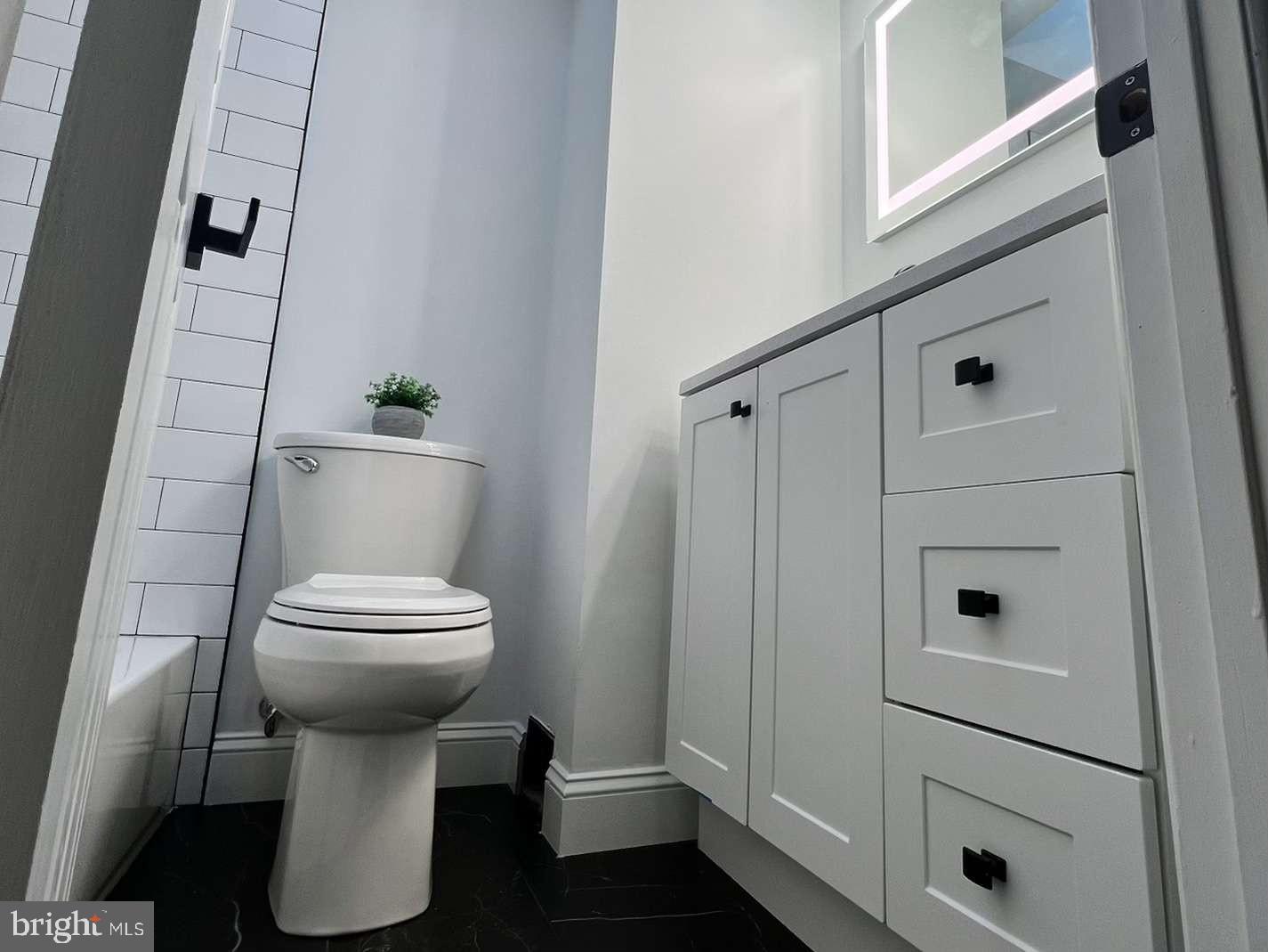 1225 Rainer Road Brookhaven, PA 19015 - Photo 9 of 15 a white toilet sitting next to a bathroom sink