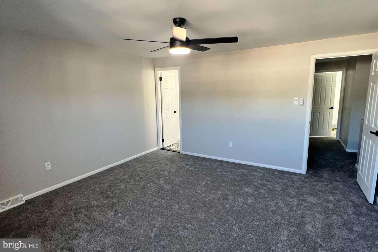 1225 Rainer Road Brookhaven, PA 19015 - Photo 10 of 15 an empty room with a ceiling fan and bathroom