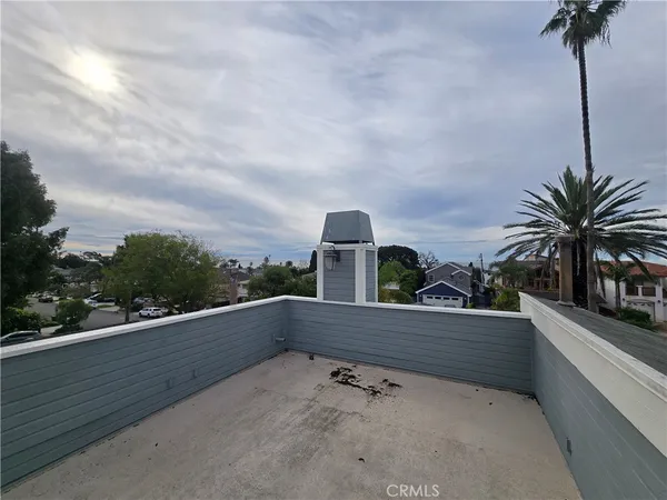 a view of roof deck with table and chairs