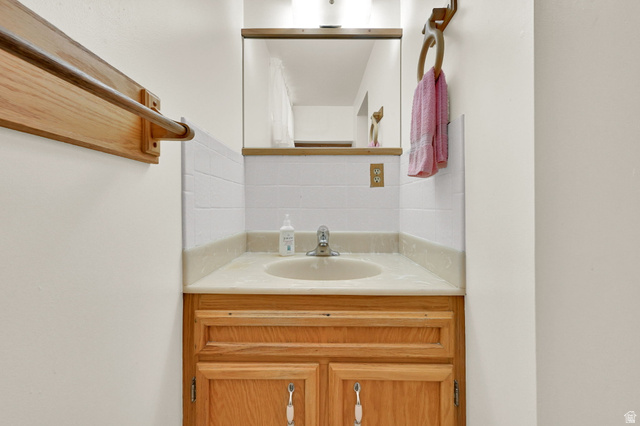 2467 South 2000 West Syracuse, UT 84075 - Photo 23 of 28 Wood-finish vanity with an integrated sink and light-toned countertop