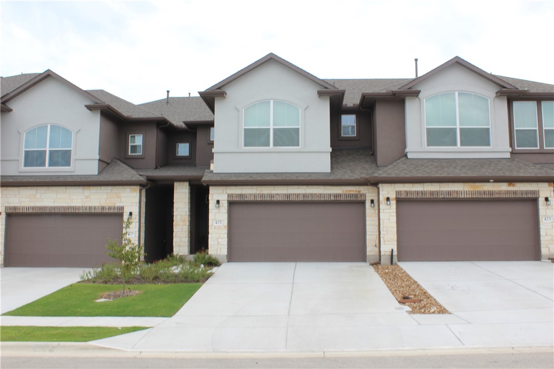 403 Rhetoric Way Pflugerville, TX 78660 - Photo 1 of 1 a front view of a house with a yard and garage