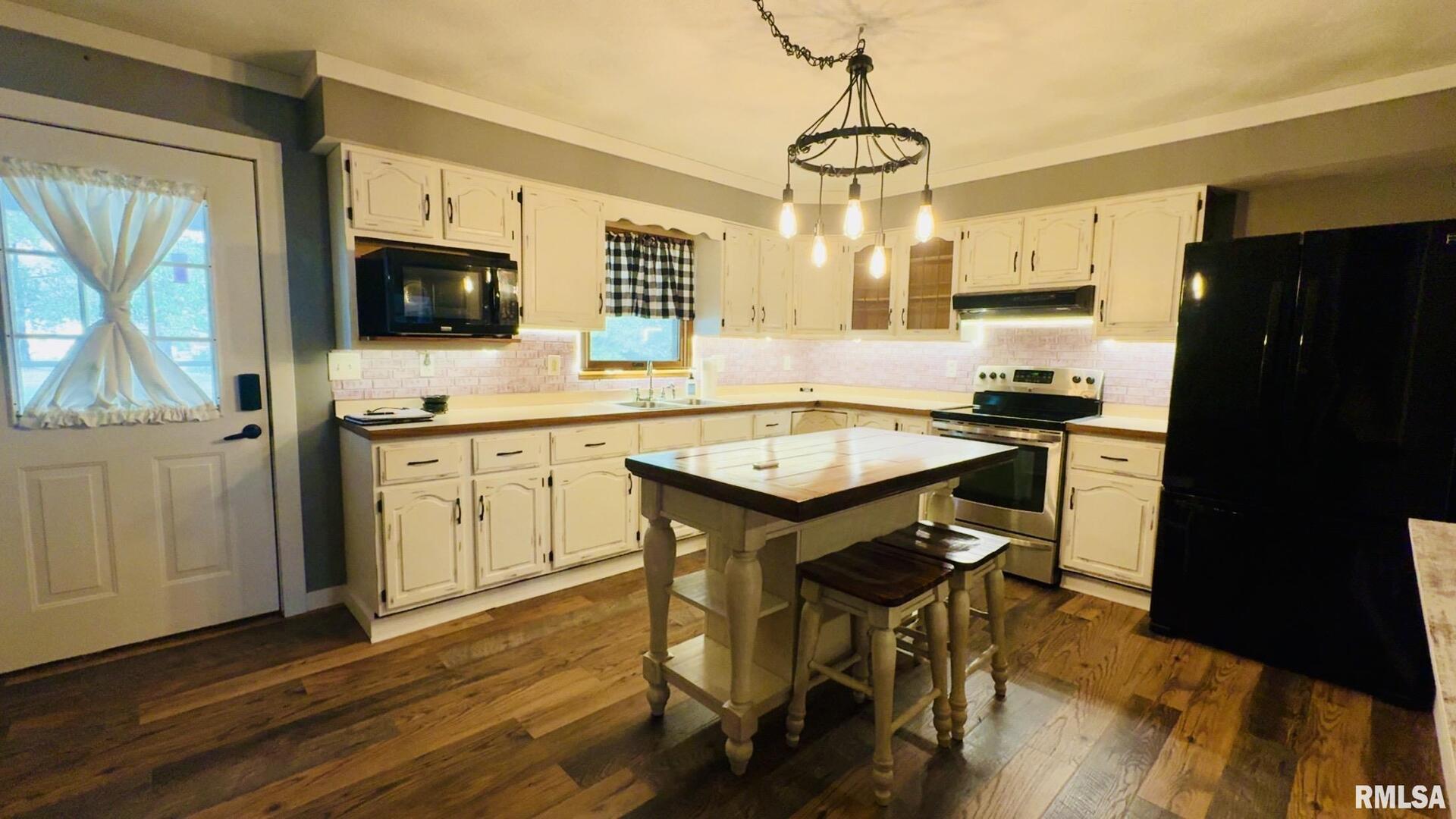 5381 Center Street Mulkeytown, IL 62865 - Photo 24 of 34 a kitchen with a sink a stove a refrigerator and wooden cabinets