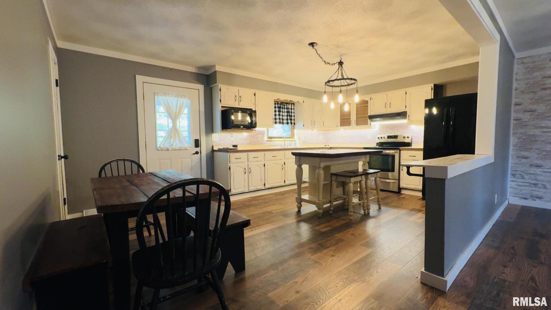 5381 Center Street Mulkeytown, IL 62865 - Photo 25 of 34 a view of a dining room with furniture window and wooden floor