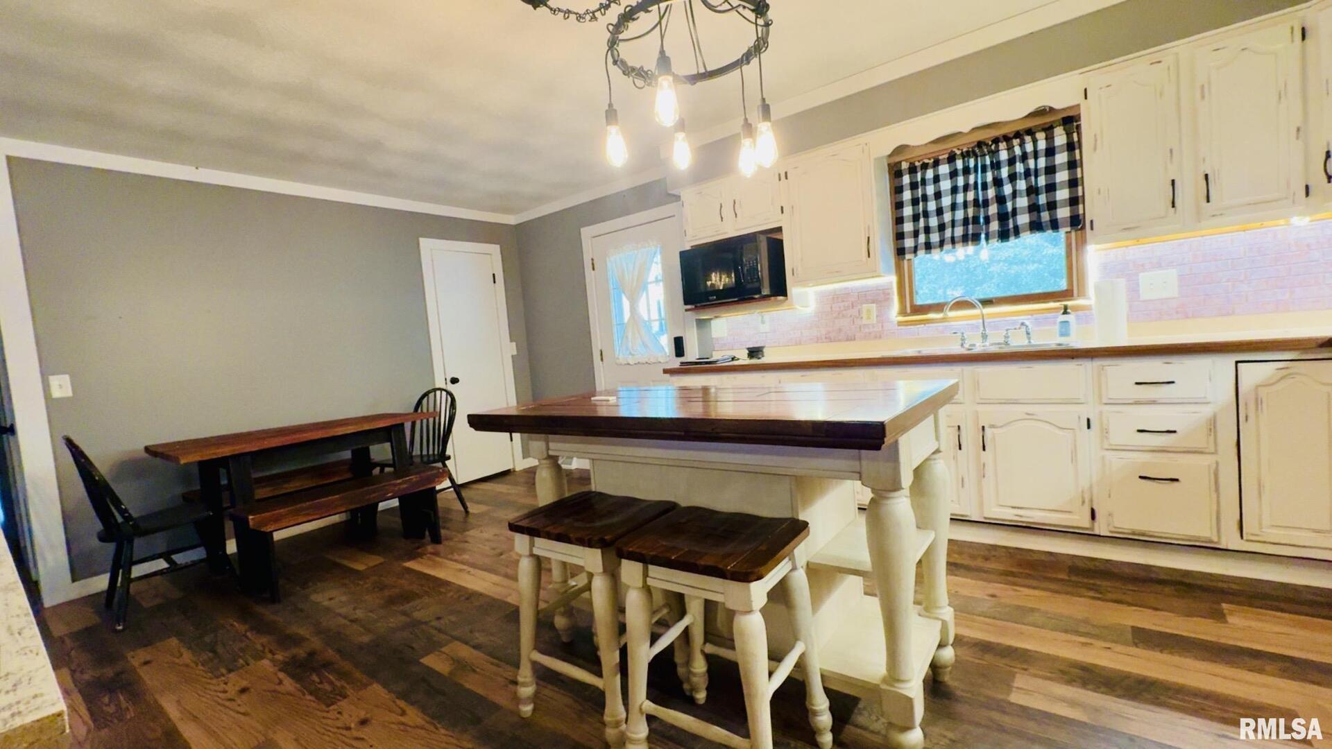 5381 Center Street Mulkeytown, IL 62865 - Photo 26 of 34 a living room with furniture a flat screen tv and kitchen view