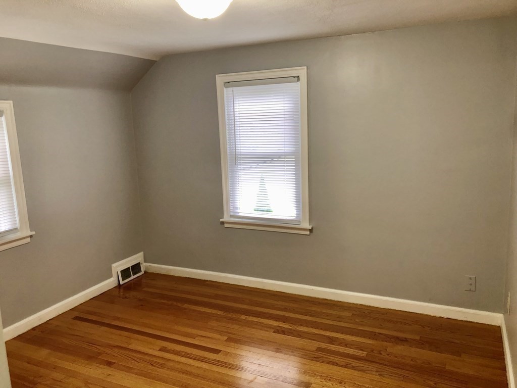 52 Mandalay Road Springfield, MA 01118 - Photo 15 of 24 a room with a wooden floor and a window