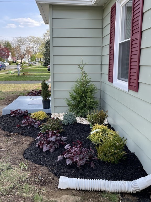 52 Mandalay Road Springfield, MA 01118 - Photo 3 of 24 a view of a backyard with plants and a fountain