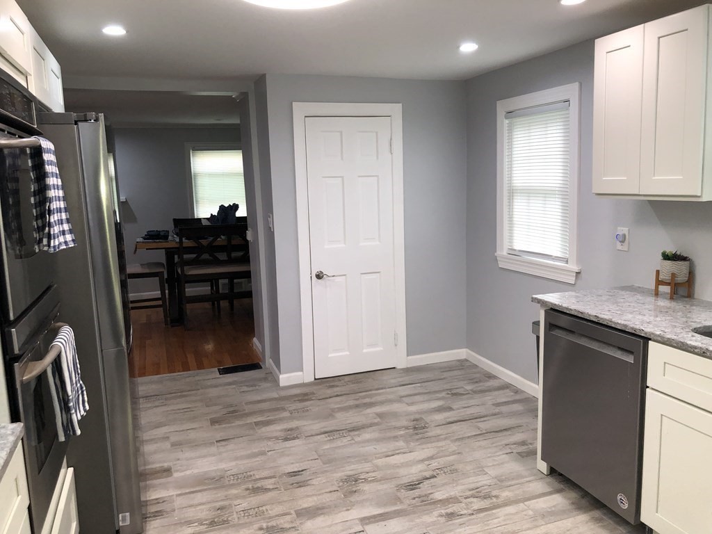 52 Mandalay Road Springfield, MA 01118 - Photo 4 of 24 a kitchen with granite countertop a refrigerator stove and sink