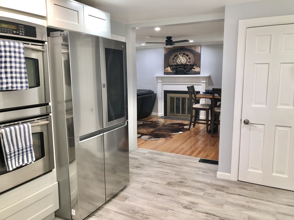52 Mandalay Road Springfield, MA 01118 - Photo 7 of 24 a kitchen with stainless steel appliances granite countertop a refrigerator microwave and wooden floor