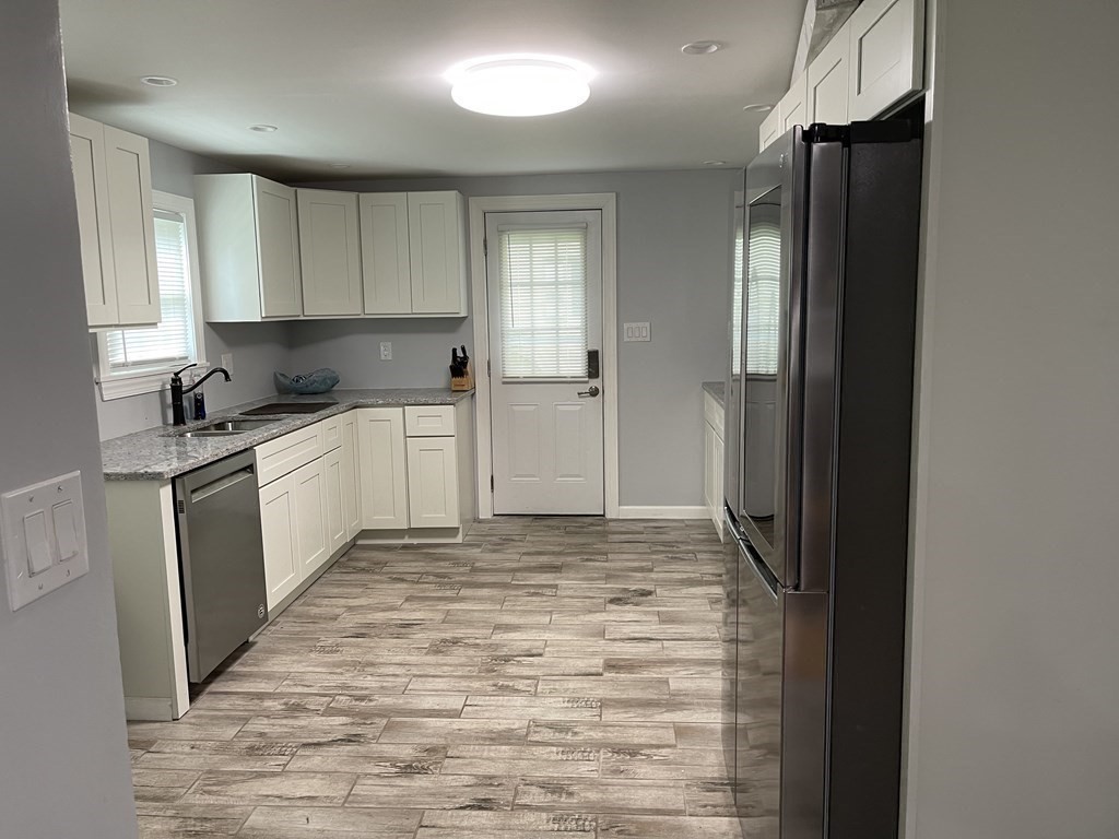 52 Mandalay Road Springfield, MA 01118 - Photo 8 of 24 a kitchen with stainless steel appliances a refrigerator and a sink