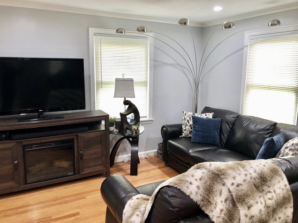 52 Mandalay Road Springfield, MA 01118 - Photo 10 of 24 a living room with furniture a flat screen tv and a fireplace