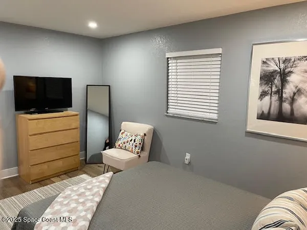a bedroom with a bed and a television
