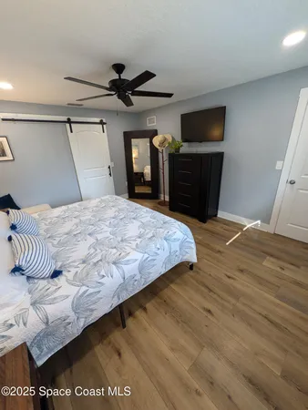 a bedroom with a bed and a television