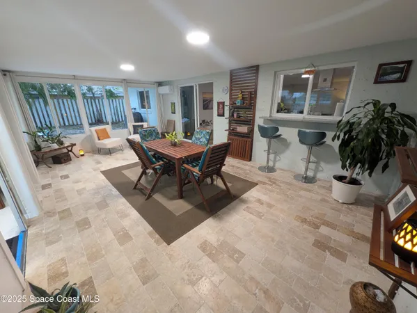a living room with furniture a window and a flat screen tv