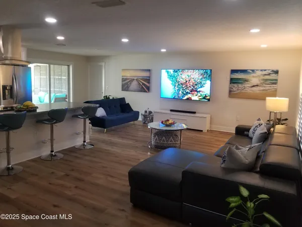 a living room with furniture a projector and a flat screen tv