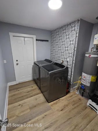 a kitchen with a stove and a wooden cabinets