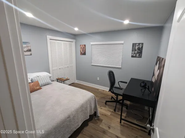 a bedroom with a bed and a desk