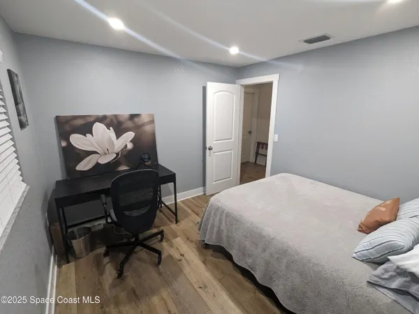 a bedroom with a bed and chair