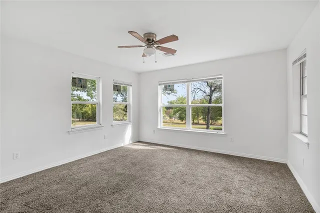 a view of an empty room with windows