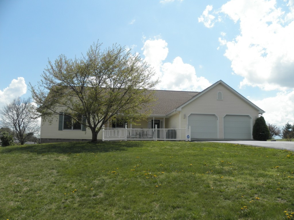 a house view with a sitting space and garden