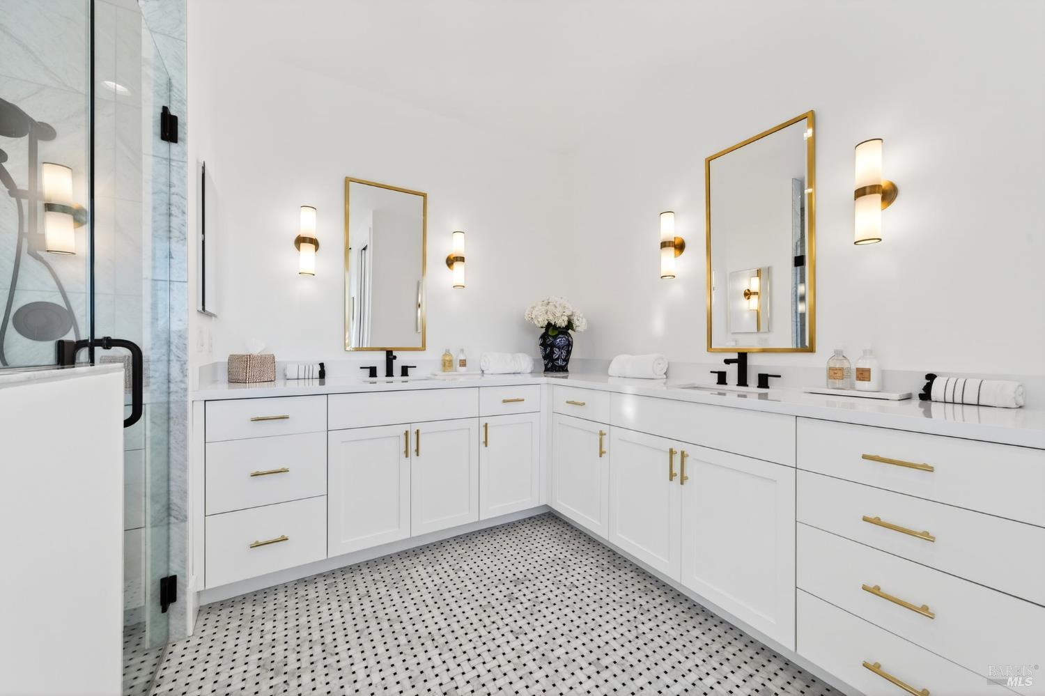 16 Upland Road St. Helena, CA 94574 - Photo 47 of 92 The upstairs primary suite has marble tile on the flooring and in the shower with trench drain. The long quartz counters and plentiful cabinetry offers plenty of space for everything.