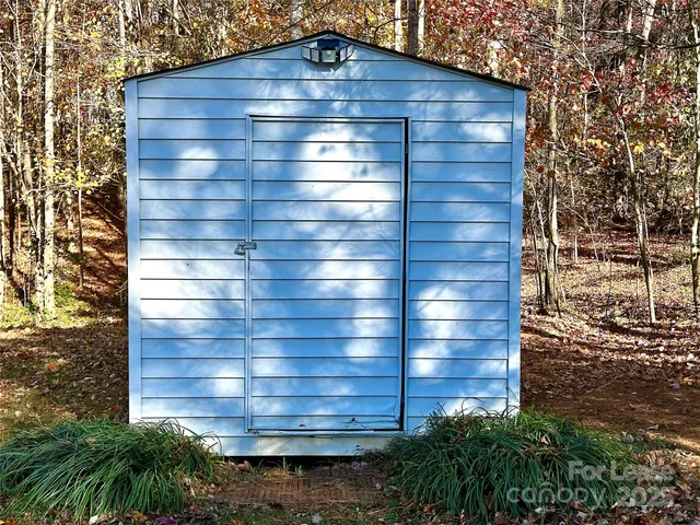a view of a backyard with large trees
