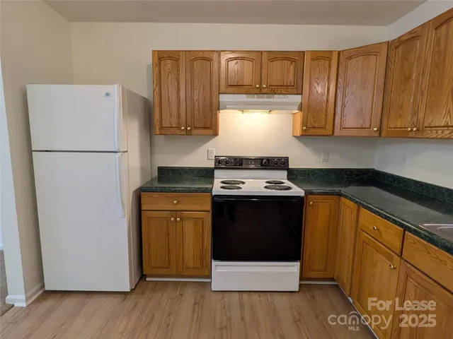 a kitchen with a refrigerator and a stove