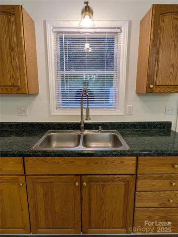 a kitchen with sink and cabinets