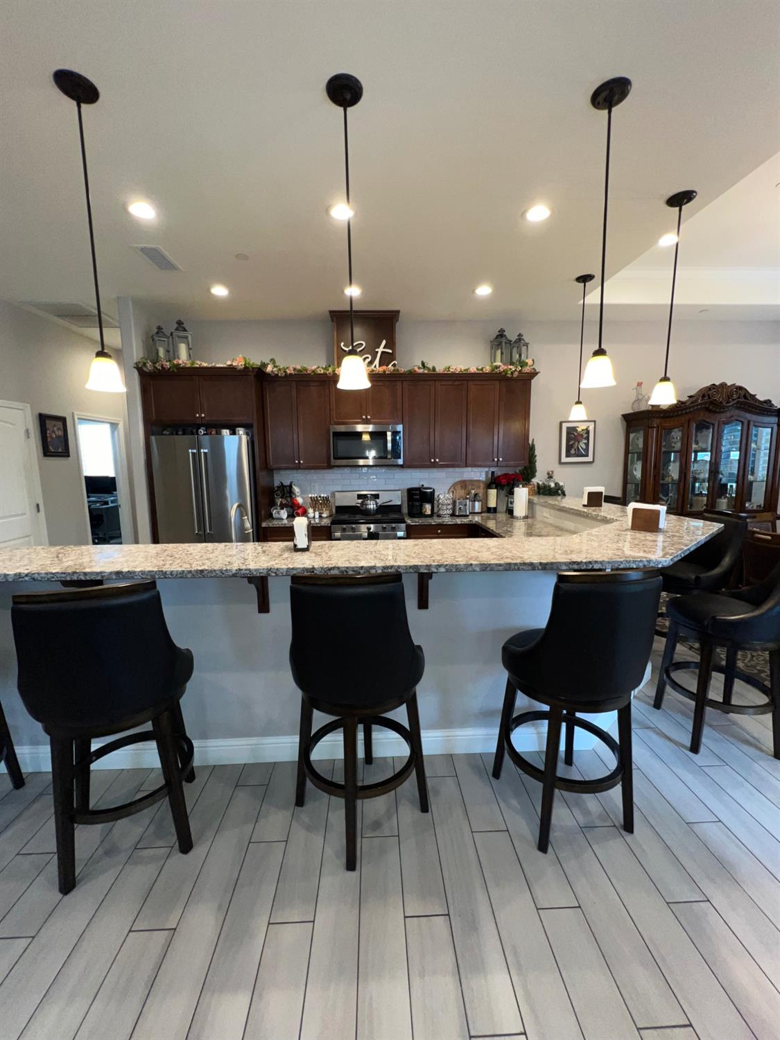 889 Coloma Place Madera, CA 93637 - Photo 18 of 61 a kitchen with a table chairs and white cabinets