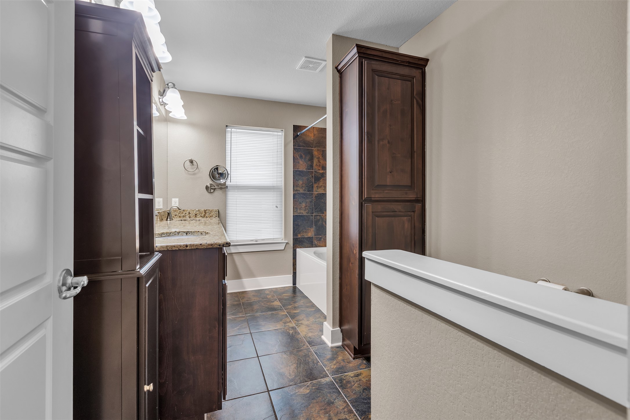 12212 Tawny Farms Road, Unit 142 Austin, TX 78748 - Photo 10 of 21 Granite counters and tiled flooring outfit this functional bathroom.