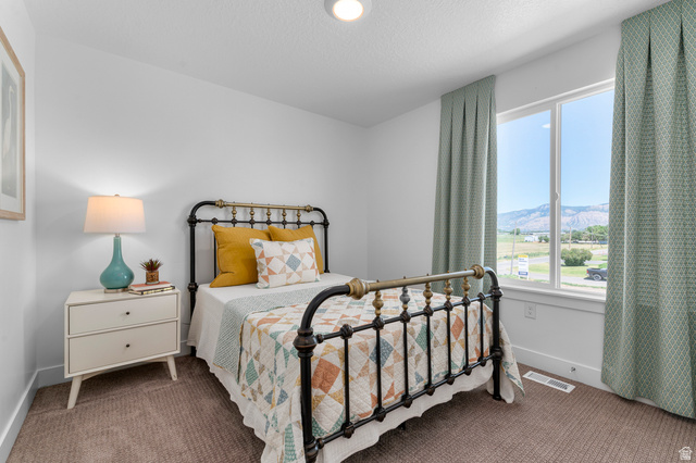 1418 West 2350th South, Unit 15 Perry, UT 84302 - Photo 19 of 22 Bright bedroom featuring a large window with mountain scenery
