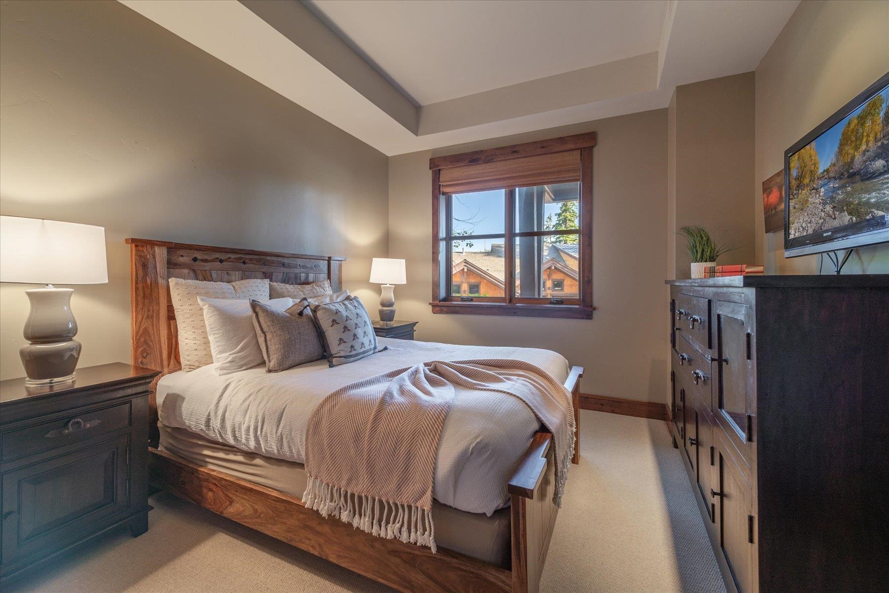 14053 Trailside Loop Truckee, CA 96161 - Photo 15 of 21 a bedroom with a bed and a flat screen tv