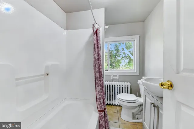 a bathroom with a bathtub sink and toilet