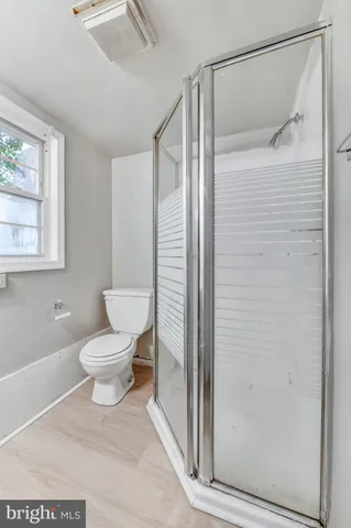 a white toilet sitting next to a bathroom sink