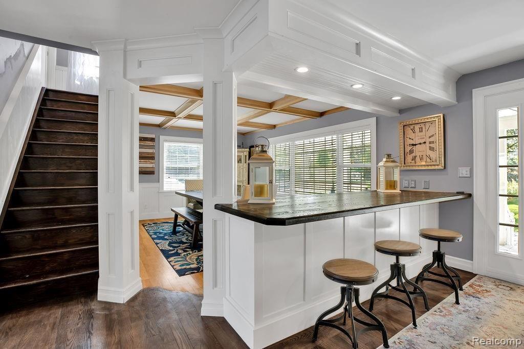 58400 Travis Road New Hudson, MI 48165 - Photo 15 of 36 Custom double sided bar in spacious wood foyer adds seating for 8 more