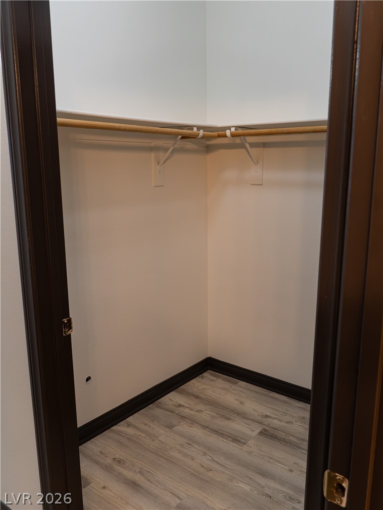 1466 Orange Jubilee Road Henderson, NV 89014 - Photo 9 of 15 A well-appointed closet features ample hanging space and durable flooring.