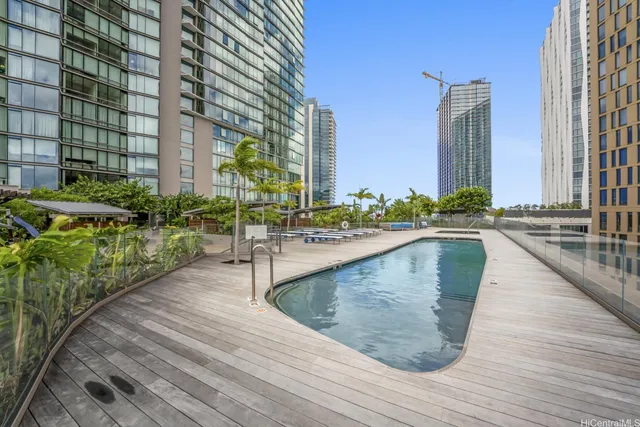 a view of swimming pool with outdoor seating and wooden floor