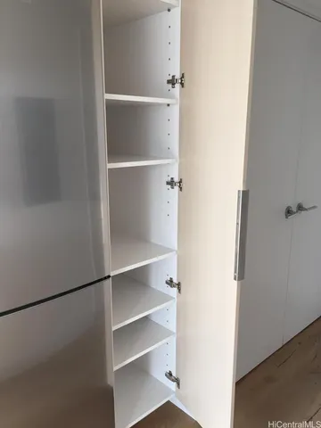 a view of walk in closet with empty racks