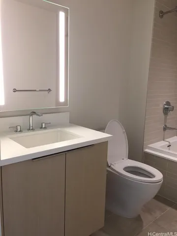 a bathroom with a toilet and a bath tub